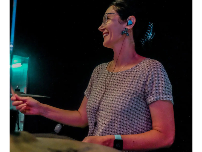 Dee playing drums